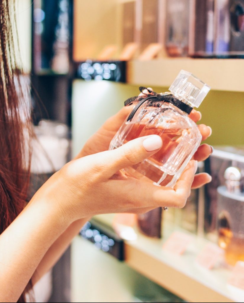 The beautiful long hair asian girl young woman in shop supermarket of cosmetics, perfumes, duty free