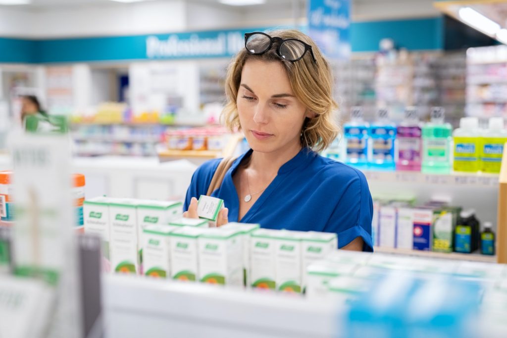 Woman choosing product in pharmacy